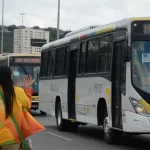 Mulher faz sinal para ônibus no Rio