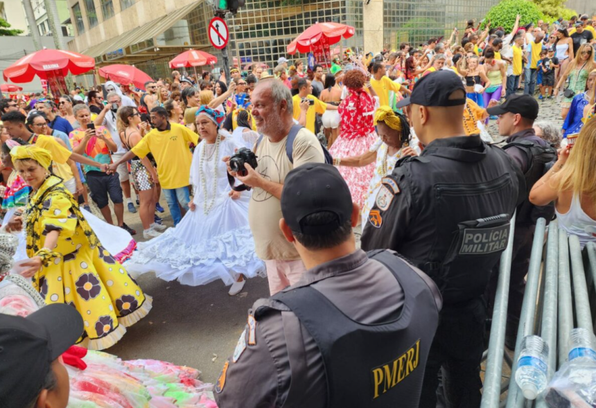 Policiais militares patrulham rua durante desfile de bloco de carnaval no Rio