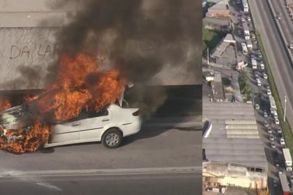 Carro pega fogo na pista lateral da Via Dutra