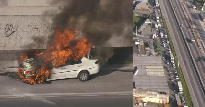 Carro pega fogo na pista lateral da Via Dutra