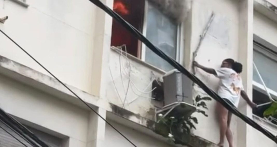 Mulher se abriga em parapeito para escapar de incêndio em prédio em Copacabana