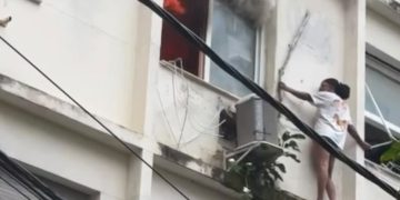 Mulher se abriga em parapeito para escapar de incêndio em prédio em Copacabana